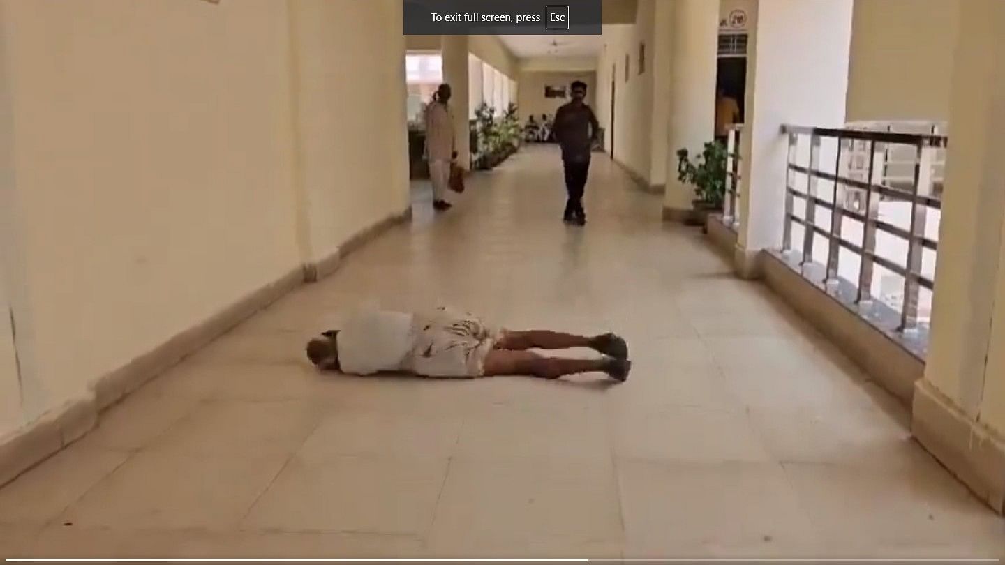 <div class="paragraphs"><p>A screengrab from the video that went viral, showing a farmer rolling on the in the district collector's office in MP.</p></div>